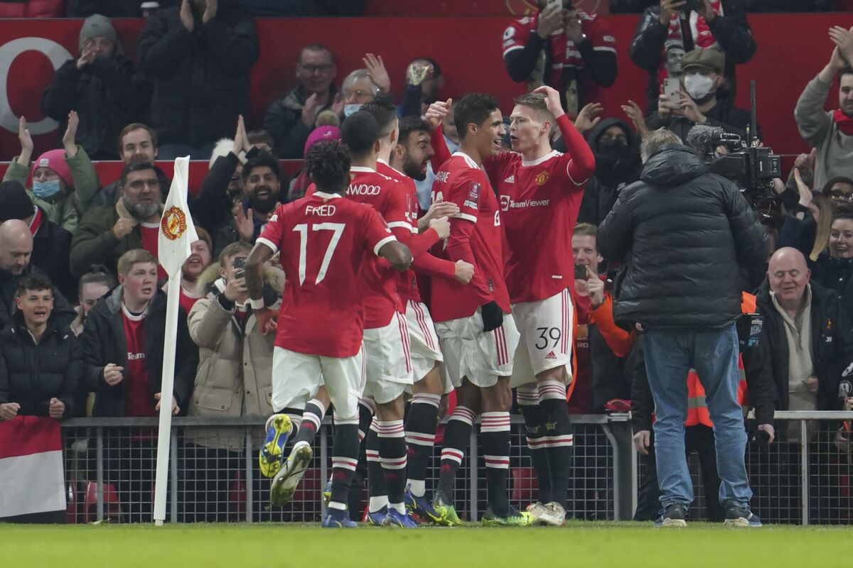 Manchester United's Scott McTominay, right, jubilates with teammates after scoring the opening goal during the English FA Cup third round soccer match between Manchester United and Aston Villa outside Old Trafford stadium in Manchester, England, Monday, Jan. 10, 2022. (AP Photo/Jon Super)