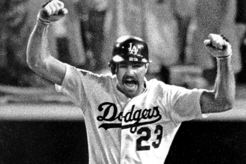 Kirk Gibson raises his arms in celebration as he rounds the bases after hitting a game?winning two run homer in the bottom of the ninth inning to beat the Oakland A's 5?4 in the first game of the World Series on Oct. 15, 1988. (For 125 anniversary sports section)