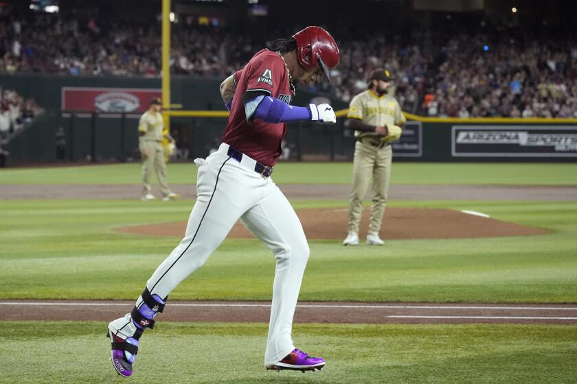 Arizona Diamondbacks' Ketel Marte, left, runs the bases after hitting a home run against San Diego Padres starting pitcher Matt Waldron, right, during the first inning of a baseball game, Sunday, May 5, 2024, in Phoenix. (AP Photo/Ross D. Franklin)