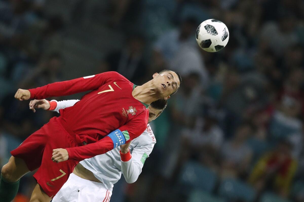 Portugal's Cristiano Ronaldo heads the ball during a World Cup match against Spain.