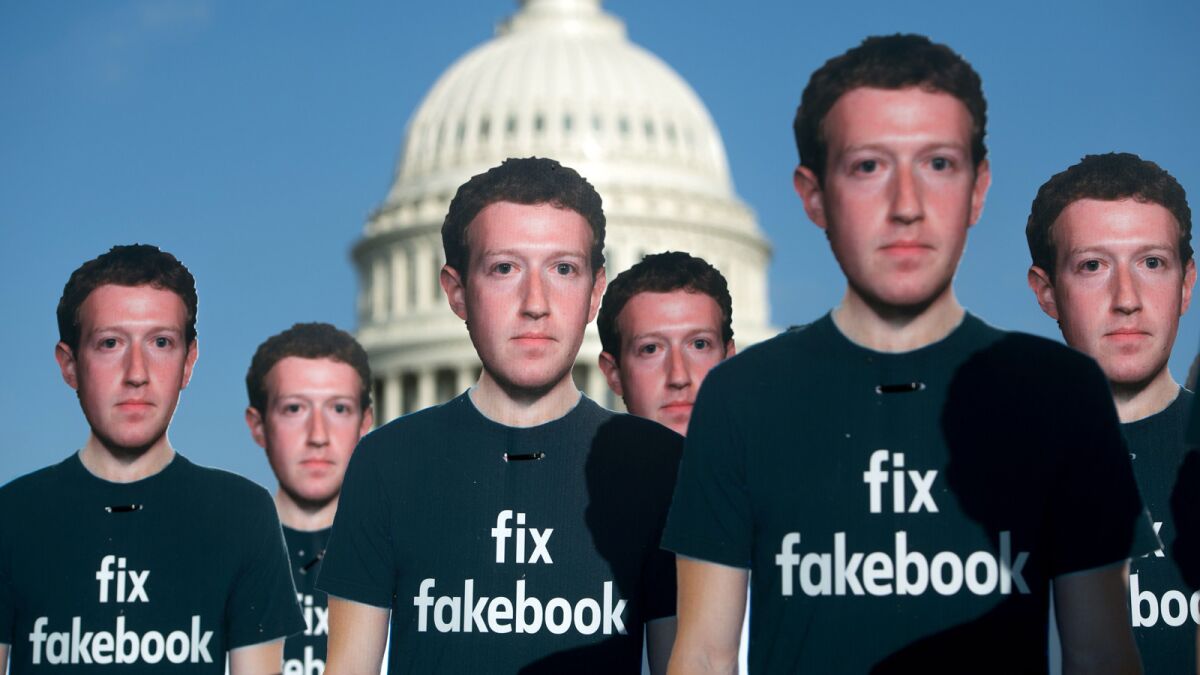 One hundred cardboard cutouts of Facebook founder and CEO Mark Zuckerberg stand outside the U.S. Capitol in April.