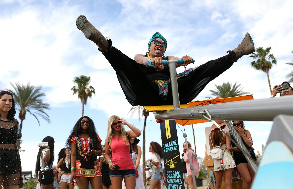 Jessica Brown, 33, of Oakland rides a teeter totter at Coachella Weekend 2 on April 21, 2018.