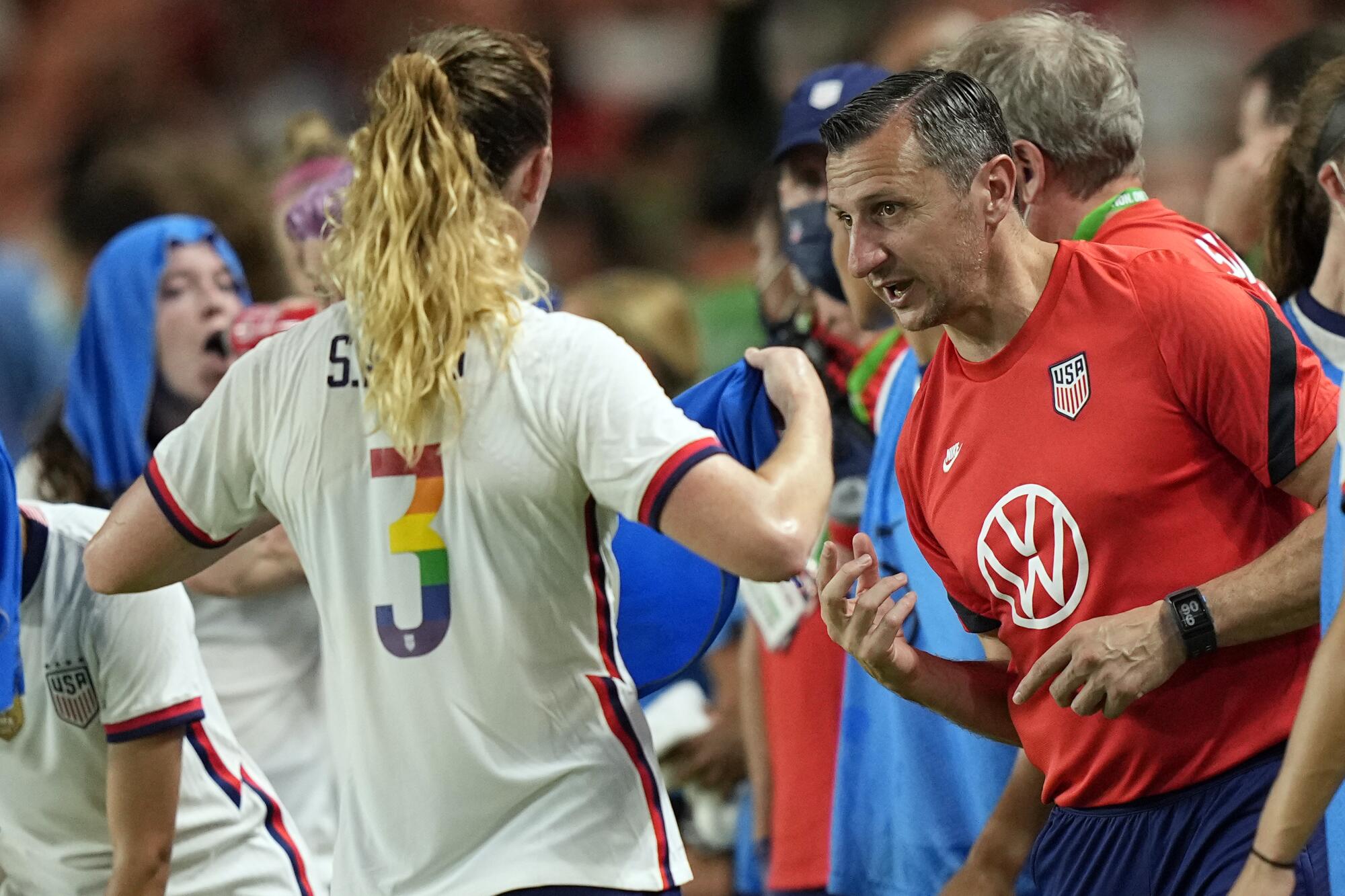 U.S. women's national soccer team coach Vlatko Andonovski talks with Samantha Mewis (3) 