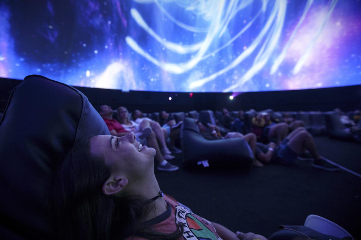 Lauren Fournell, 22, of Manhattan Beach, watches a 360-degree sensory experience inside a large-scale projection dome at the 2017 festival.