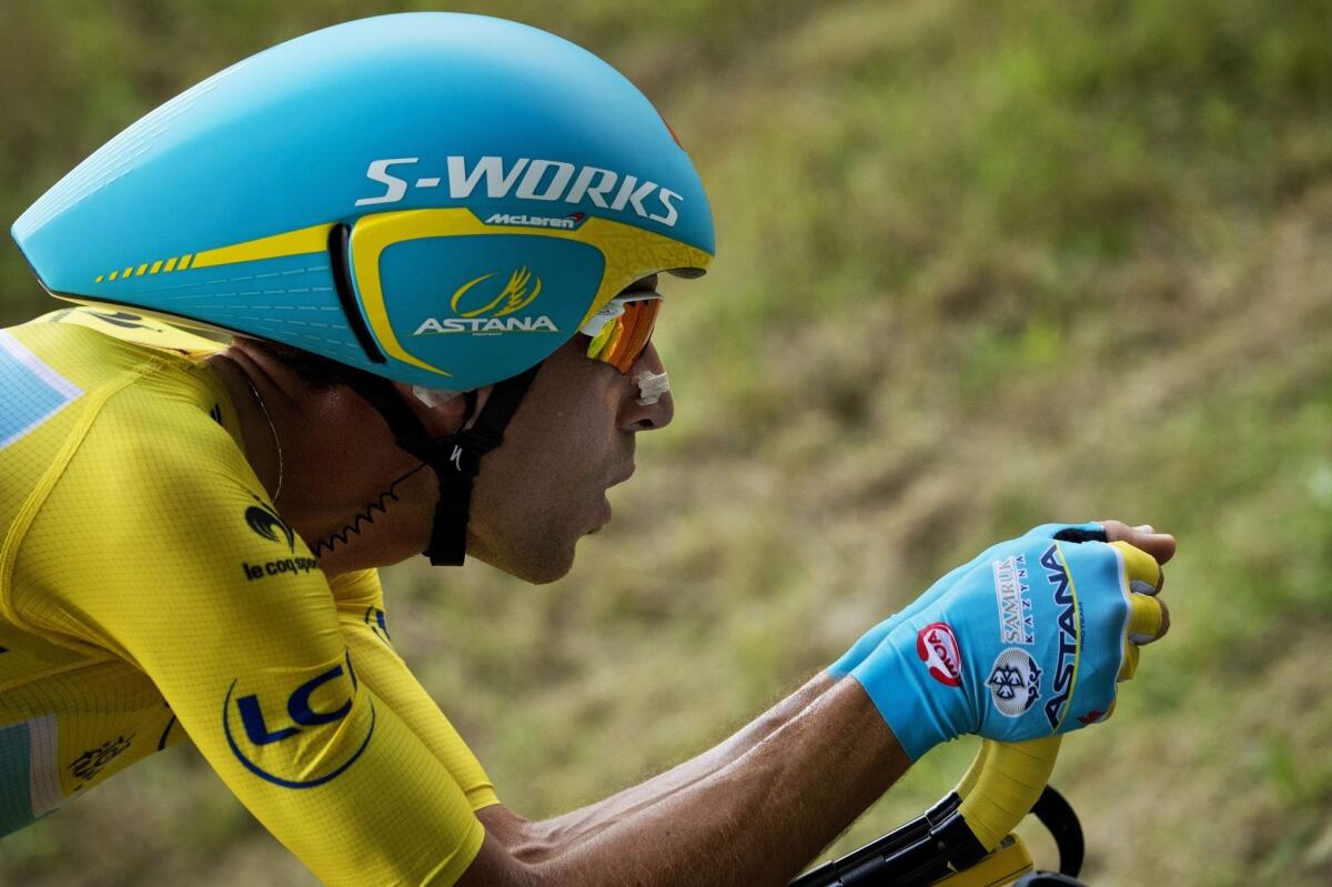 Vincenzo Nibali of Italy wears the yellow jersey as he rides during the 20th stage of the Tour de France, a 54KM individual time trail. Nibali leads by several minutes and is all but certain to win the Tour de France in the final stage Sunday.