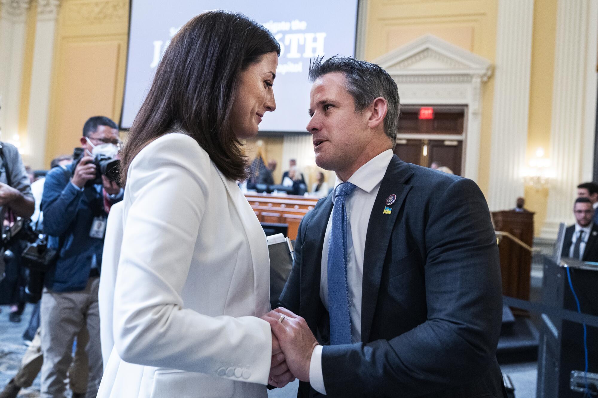 Cassidy Hutchinson, an aide to former White House Chief of Staff Mark Meadows, greets Rep. Adam Kinzinger, R-Ill.