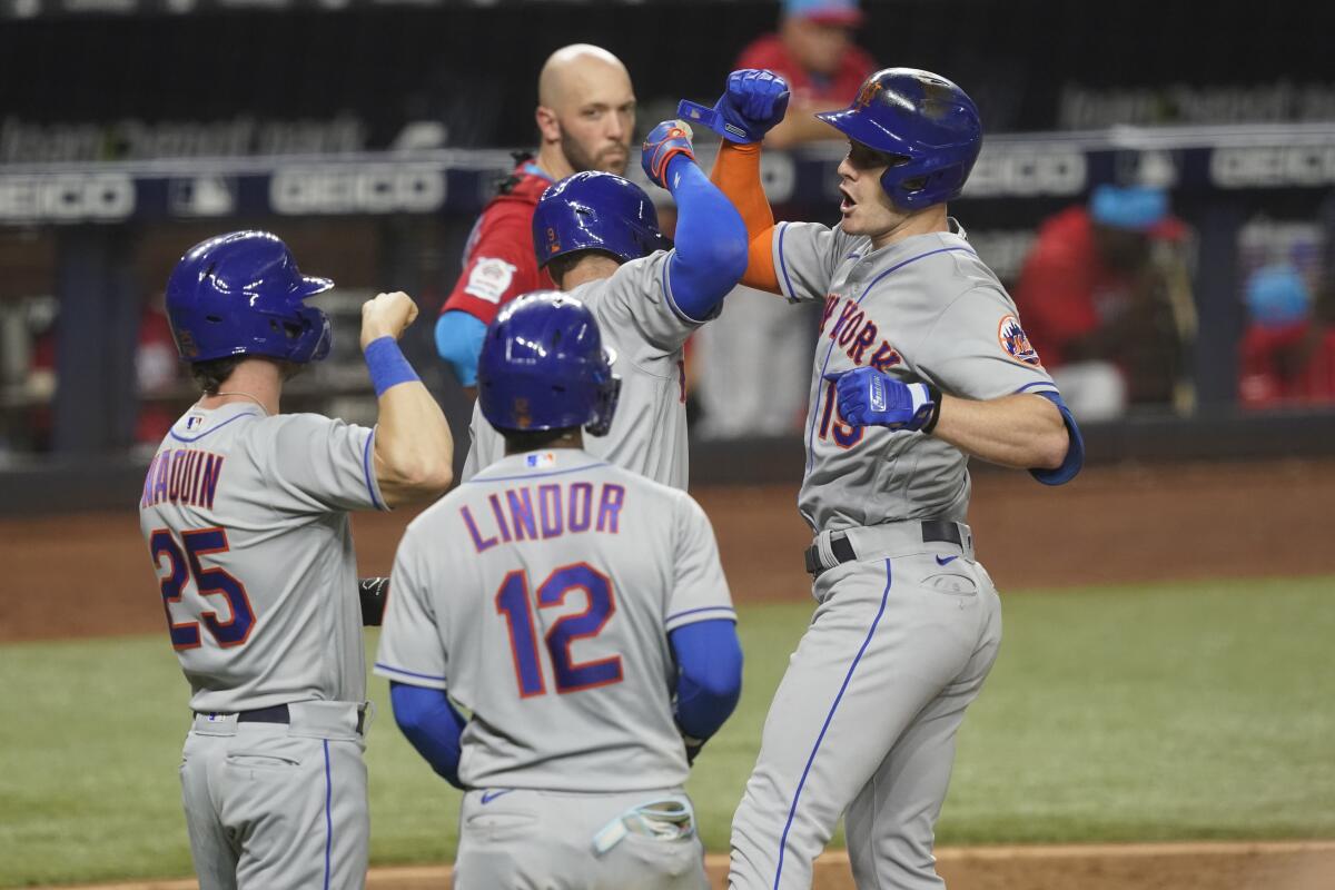 New York's Mark Canha is congratulated by his teammates after hitting a grand slam.