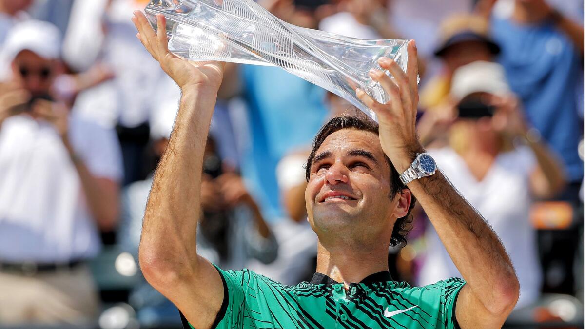 Roger Federer holds the winner's trophy after defeating Rafael Nadal in the Miami Open championship match Sunday.