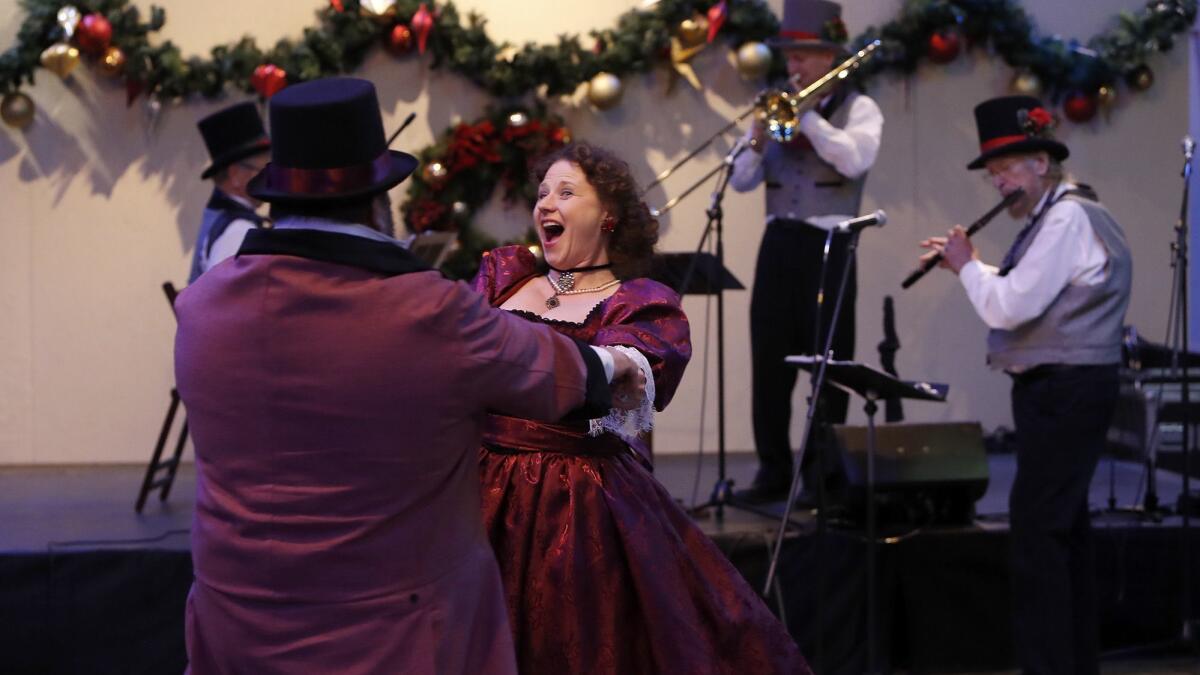 There figures to be a lot of dancing at the two New Year’s Eve parties at Winter Fest OC in Costa Mesa, though the music won’t be polka, as pictured here at the festival’s Dickens Village. The celebrations Monday night will feature Katy Perry and Pink tribute bands.