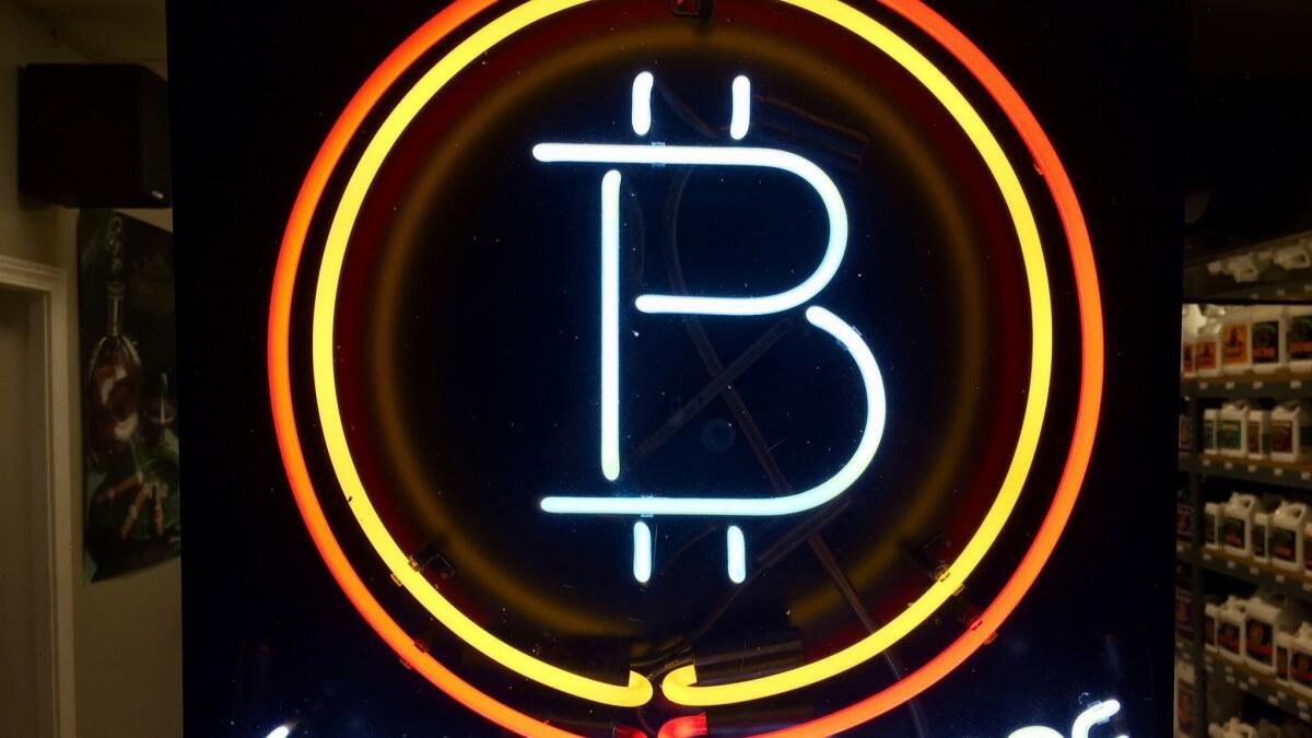 A sign in a business indicates it accepts cryptocurrency.