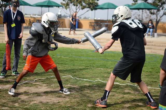 Keith Closs, left, 13, and Josh Magnes, 14, of Crossroads School in Santa Monica compete in the gladiator fights at this year's California Junior Classical League's statewide convention at Sage Hill School in Newport Beach on Saturday.