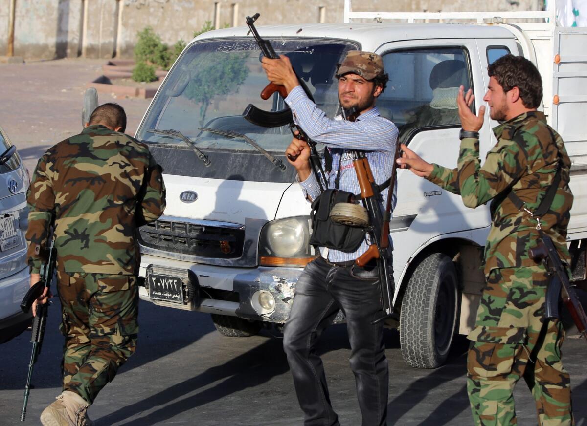 An Iraqi civilian in Baghdad, center, volunteers to fight alongside security forces against militants who have taken over several northern Iraqi cities.