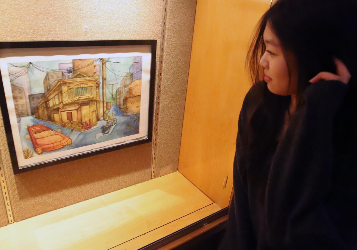 Joy Qu, 17, a Sage Hill High School student, next to her art piece titled "Underwater City."
