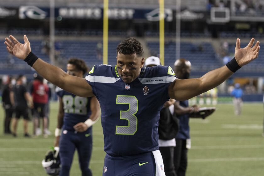 Seattle Seahawks quarterback Russell Wilson gestures as he walks off the field after an NFL preseason football game against the Los Angeles Chargers, Saturday, Aug. 28, 2021, in Seattle. The Seahawks won 27-0. (AP Photo/Stephen Brashear)