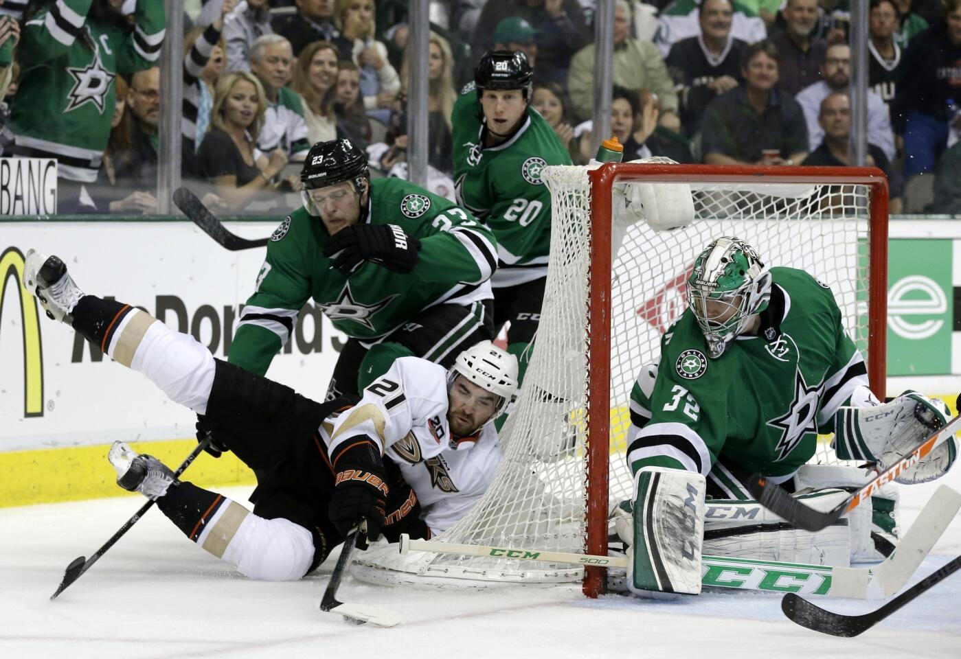 Ducks right wing Kyle Palmieri falls as he attempts a wrap-around shot in front of Dallas Stars defenseman Kevin Connauton and goalie Kari Lehtonen during the second period of the Ducks' 4-2 loss in Game 4 of the Western Conference quarterfinals.