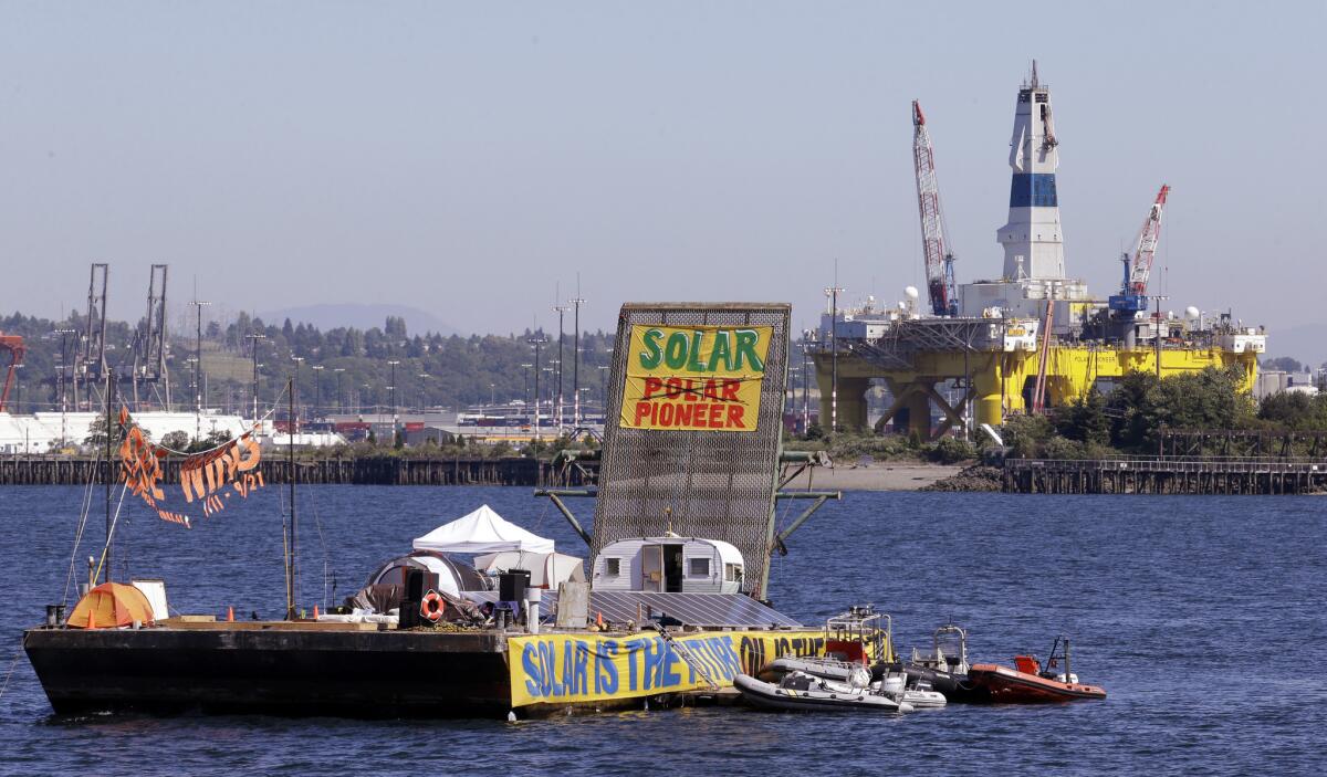 A barge used by protesters is anchored in view of the Arctic oil drilling rig Polar Pioneer in Seattle's Elliott Bay in June. Six activists demonstrating against Shell's rig were arrested as they blocked entrances to the city's port.