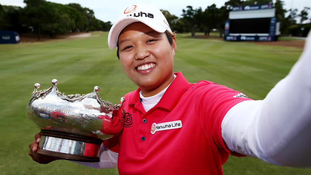 Haru Nomura pretends to take a selfie with the trophy after winning the Women's Australian Open on Sunday.