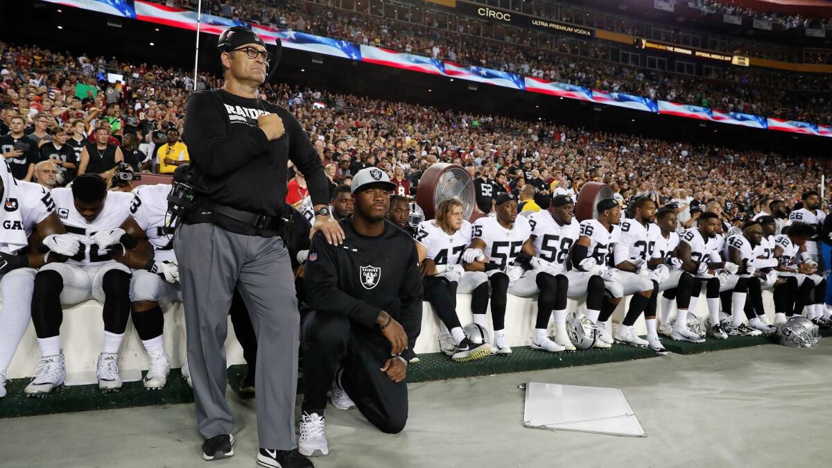 Some Oakland Raiders kneel during the playing of the national anthem before an NFL football game against the Washington Redskins in Landover, Md., on Sept. 24.