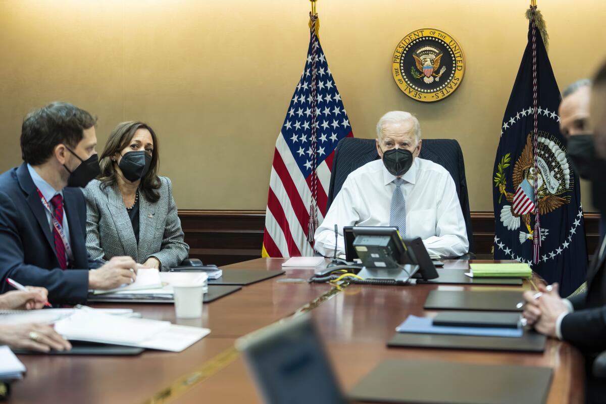 FILE - In this image provided by The White House, President Joe Biden and Vice President Kamala Harris and members of the President's national security team observe from the Situation Room at the White House in Washington, on Feb. 2, 2022, the counterterrorism operation responsible for removing from the battlefield Abu Ibrahim al-Hashimi al-Qurayshi, the leader of the Islamic State group. Biden and top national security officials have cited the recent strike killing al-Qaida head Ayman al-Zawahri as evidence that America maintains an “over-the-horizon” counterterrorism capacity in Afghanistan after the withdrawal. (Adam Schultz/The White House via AP, File)