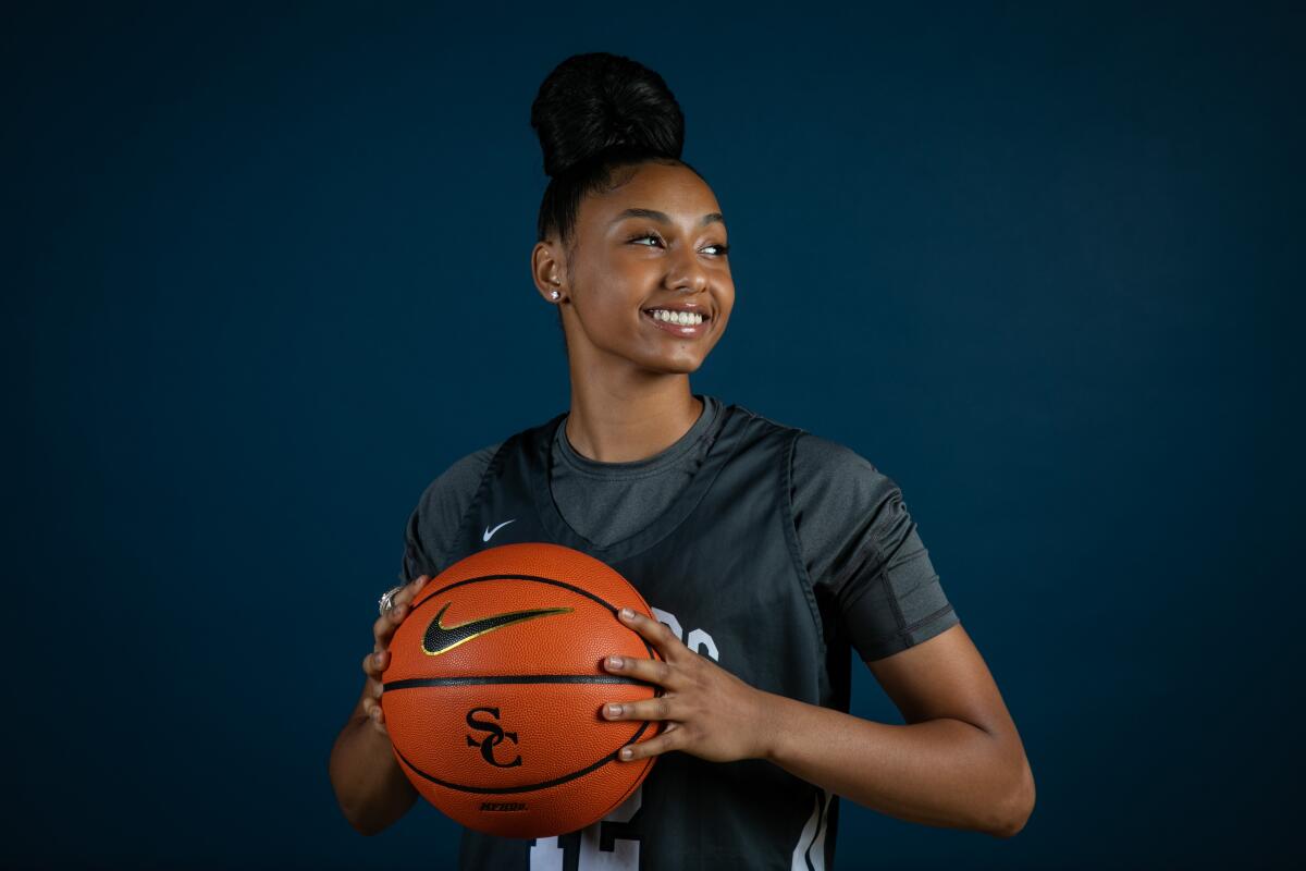 Juju Watkins holds a basketball with two hands