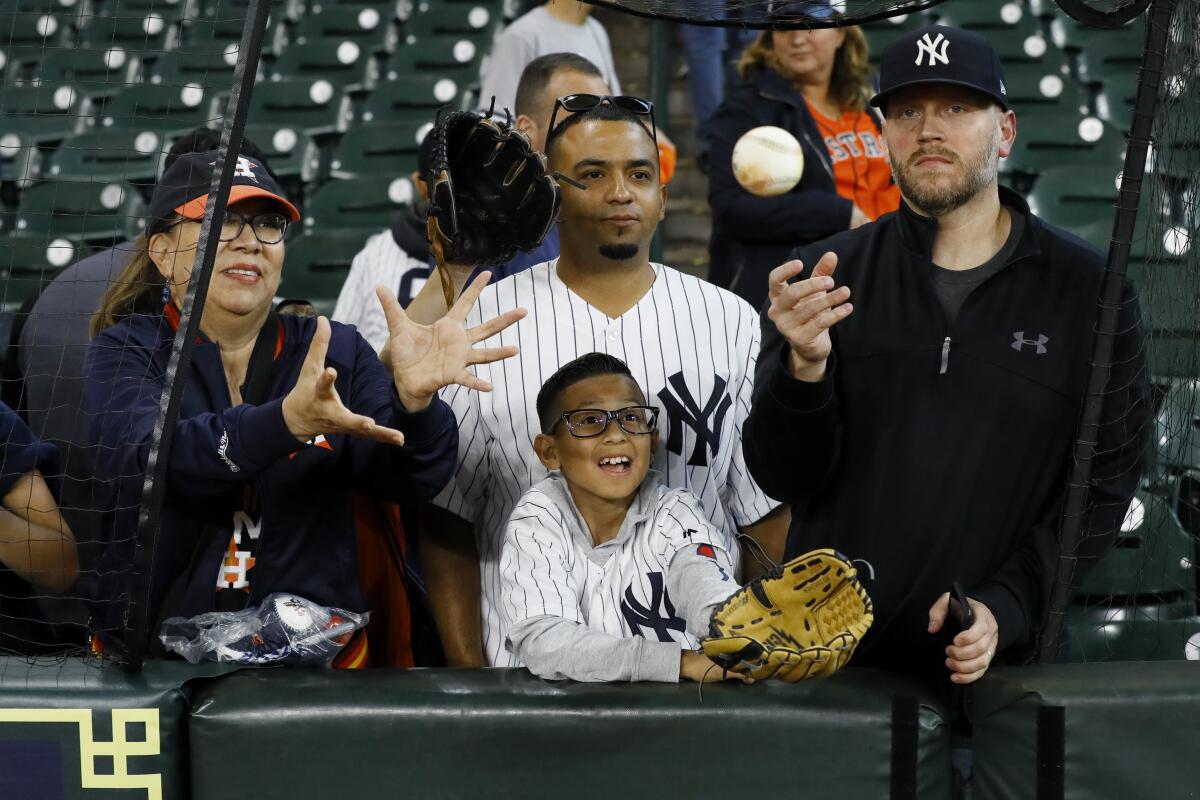 Fans wait for a ball during batting practice before Game 1 of the American League Championship Series between the Houston Astros and the New York Yankees in October.