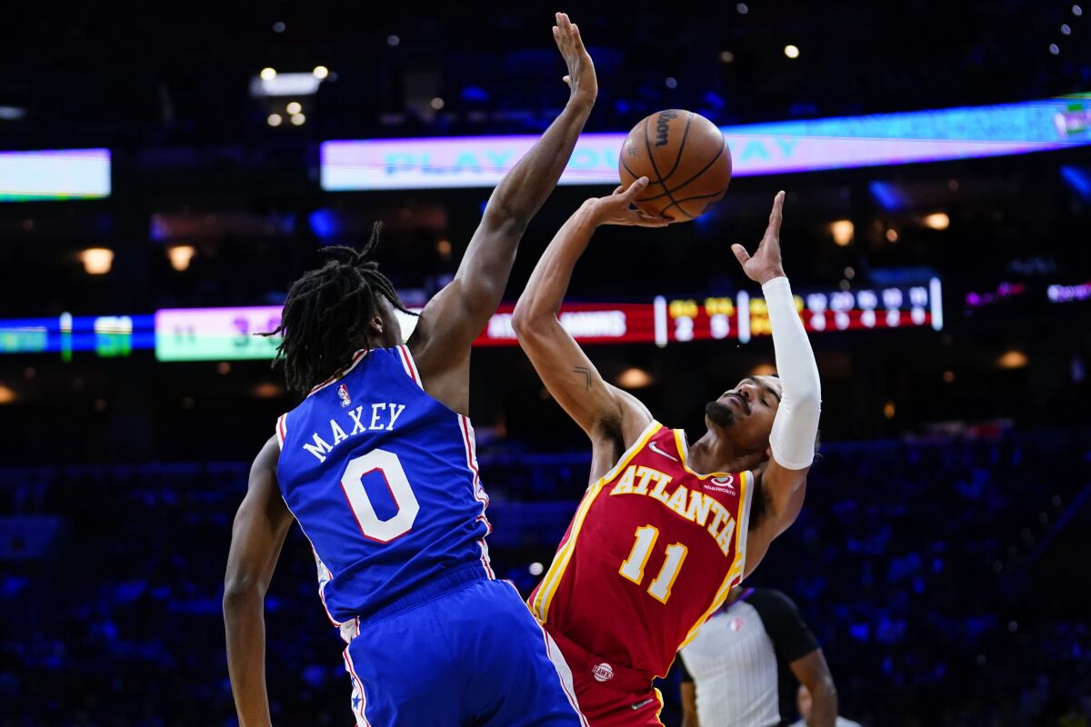 Atlanta Hawks' Trae Young, right, tries to get a shot past Philadelphia 76ers' Tyrese Maxey during the first half of an NBA basketball game, Saturday, Oct. 30, 2021, in Philadelphia. (AP Photo/Matt Slocum)