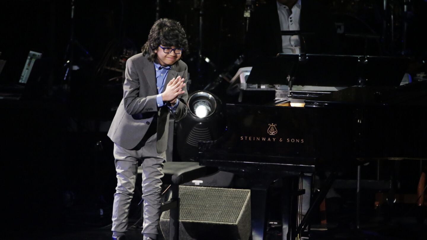 Jazz pianist Joey Alexander, 12, takes a bow following his performance at the pre-telecast show.