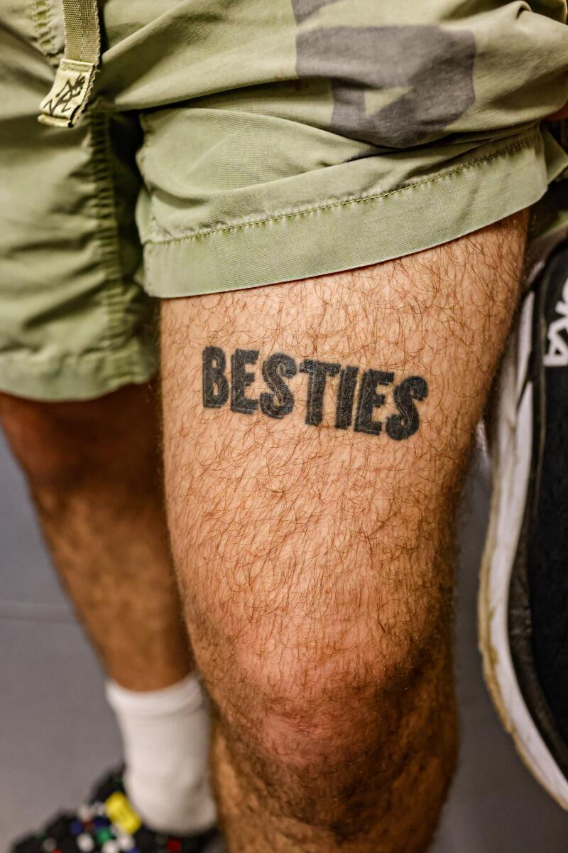 A patron shows off a "Besties" thigh tattoo from Asia Rain.