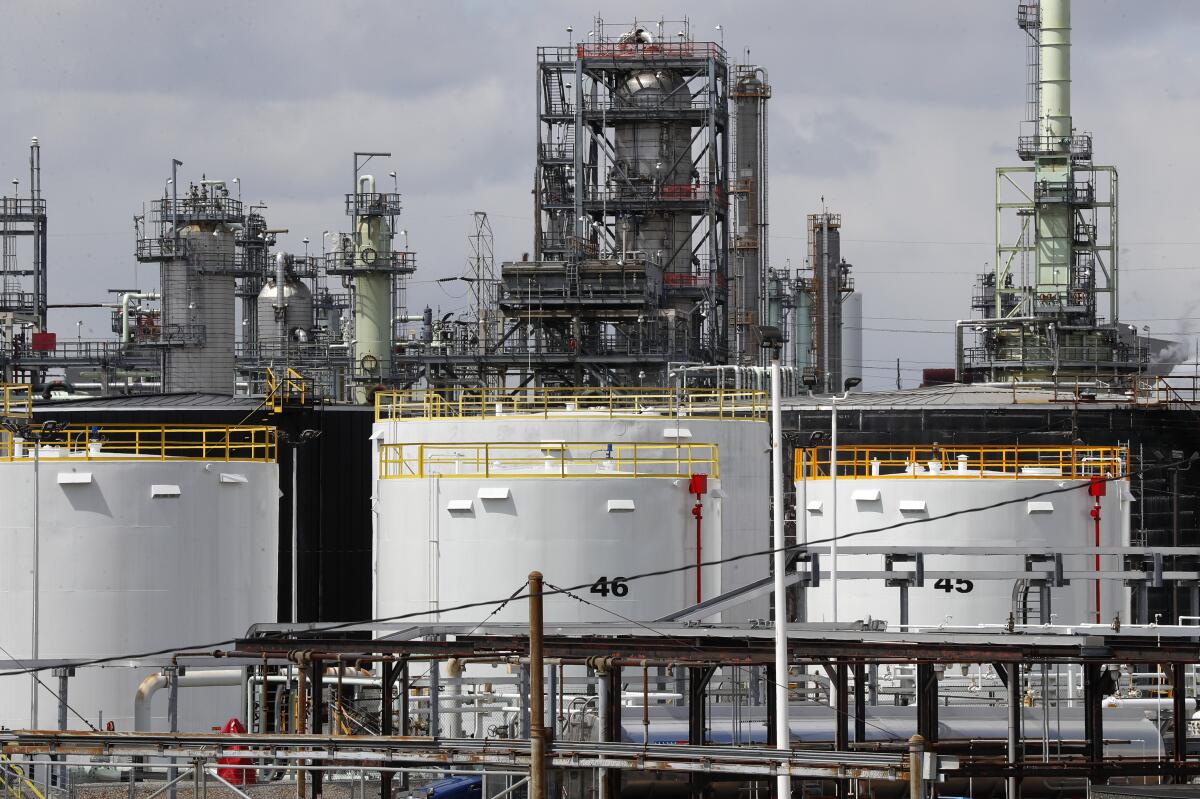 Storage tanks are shown at a refinery