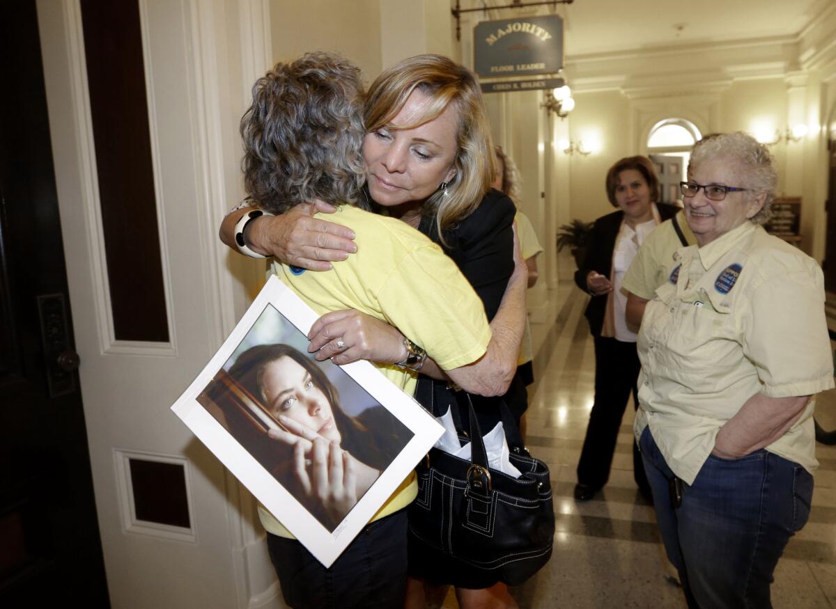 After a right-to die measure was approved by the California Assembly on Sept. 9., Debbie Ziegler holds a photo of her daughter, Brittany Maynard, a 29-year-old California woman with brain cancer who moved to Oregon to legally end her life.