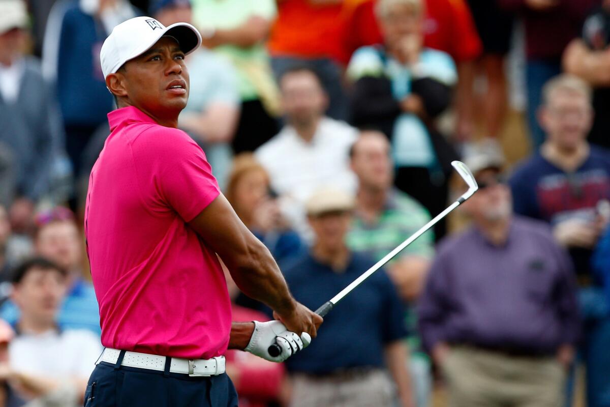 Tiger Woods watches his tee shot at No. 7 during the first round of the Phoenix Open on Thursday.