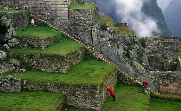 Tourists climb the stone stairs of Machu Picchu in 1995.