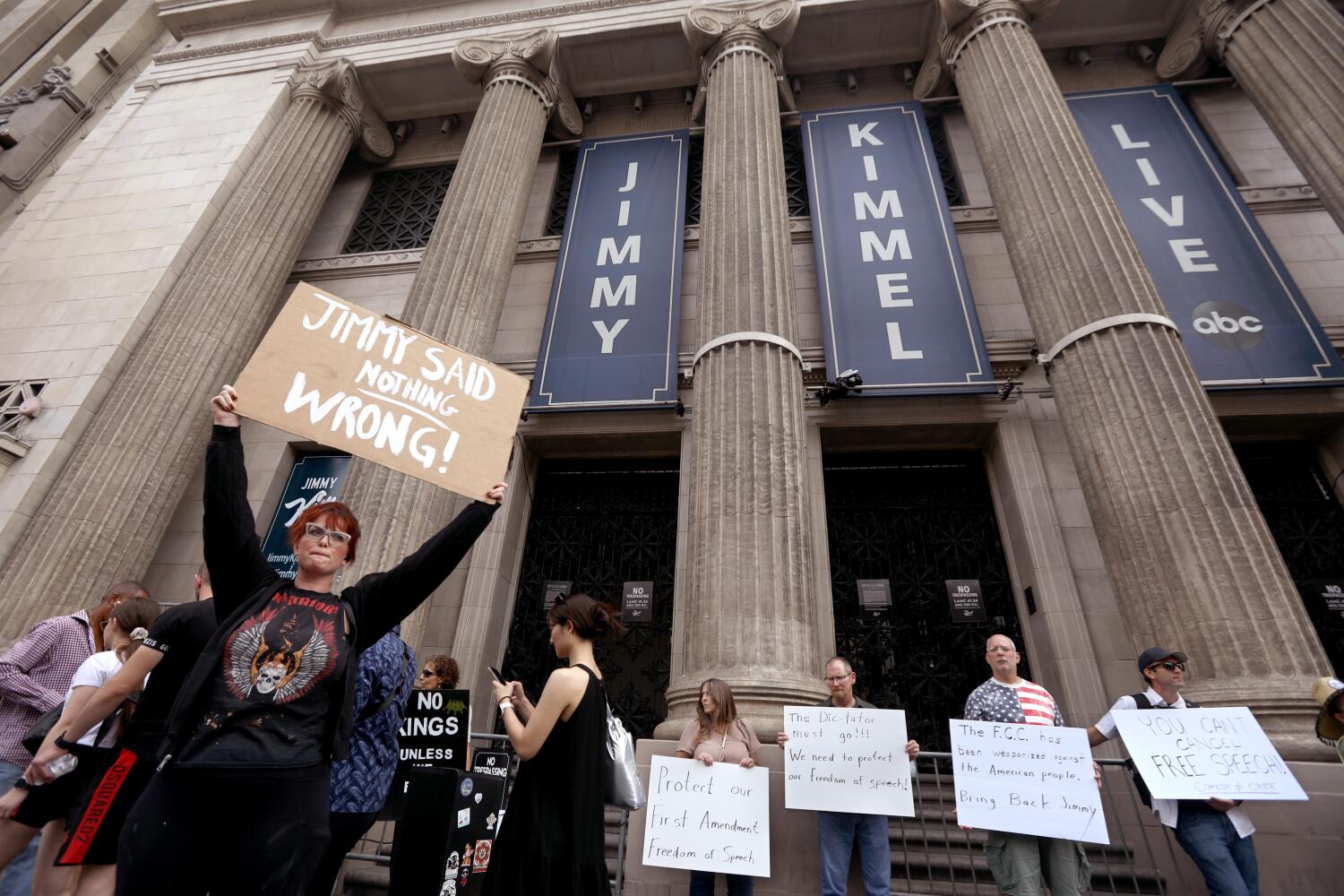 HOLLYWOOD, CA - SEPTEMBER 18, 2025 -- People protest in front of the Jimmy Kimmel Theater a day after ABC pulled the late-night host off air indefinitely over comments he made about the shooting of right-wing influencer Charlie Kirk in Hollywood on September 18. 2025. (Genaro Molina/Los Angeles Times)