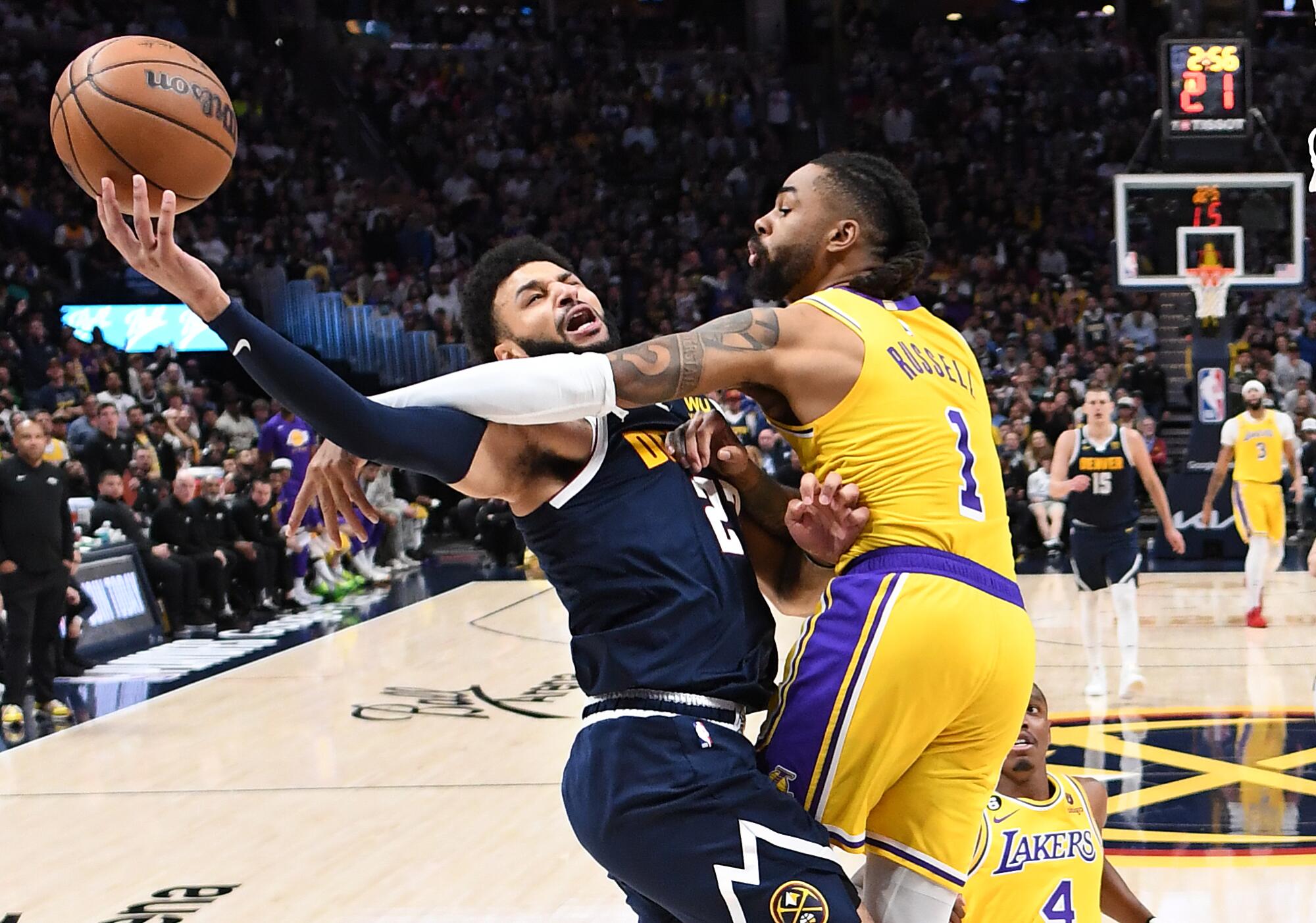Lakers guard D'Angelo Russell fouls Nuggets guard Jamar Murray in the first quarter.