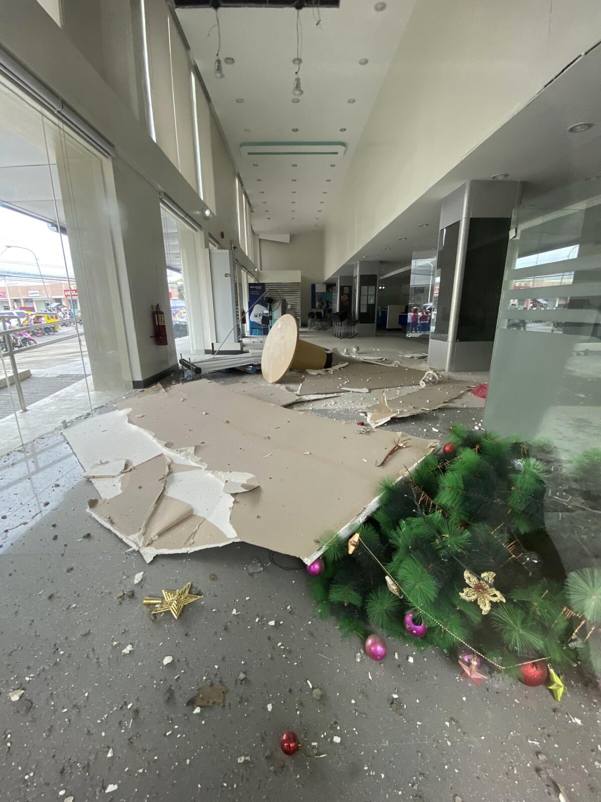 In this photo provided by the Philippine Red Cross, a Christmas tree and other debris lie on the ground inside a building after a strong earthquake shook Digos, Davao del Sur province, southern Philippines on Sunday Dec. 15, 2019. A magnitude 6.9 quake jolted the southern Philippines on Sunday, causing a three-story building to collapse and prompting people to rush out of shopping malls, houses and other buildings in panic, officials said. (Philippine Red Cross via AP)