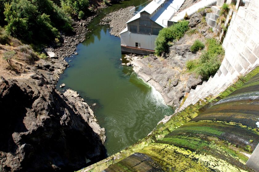 FILE - In this Aug. 21, 2009 file photo, water trickles over Copco 1 Dam on the Klamath River outside Hornbrook, Calif. The process to relicense the hydroelectric dam system on the Klamath River has restarted again as historic settlement agreements to remove four of the dams have thus far failed to make headway in Congress this year. The Klamath River basin, which straddles Oregon and California, has long been the site of intense political fights over the sharing of scarce water between farms and fish. The agreements to remove the dams, hammered out by farmers, tribes, environmentalists and states, are a compromise aimed to restore the river for imperiled salmon and steelhead, and give farmers greater certainty about irrigation water. (AP Photo/Jeff Barnard, File)