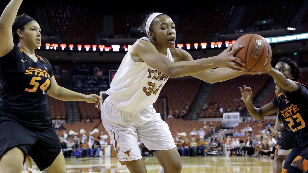 Texas center Imani Boyette collects a pass in th epost against Oklahoma State defenders Kaylee Jensen (54) and Roddricka Patton (23) during a Big 12 game on Feb. 10.