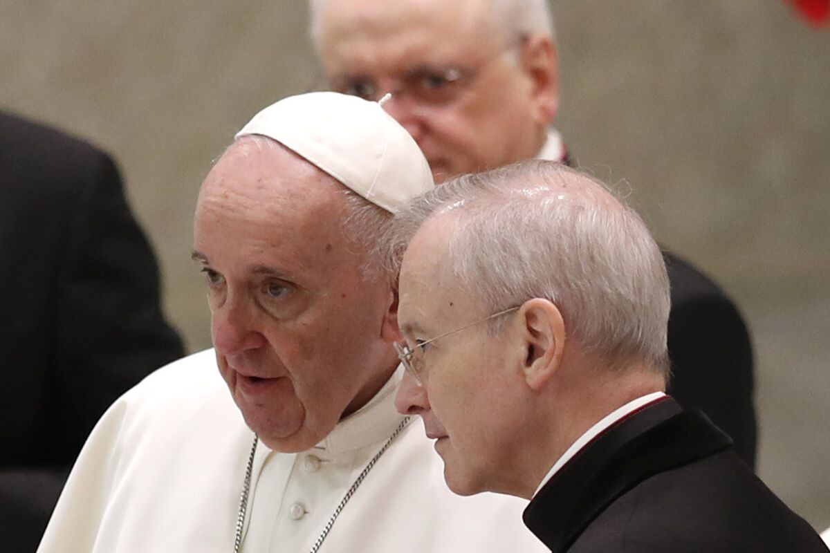 Pope Francis and Msgr. Luis Maria Rodrigo Ewart converse at the Vatican on Wednesday.