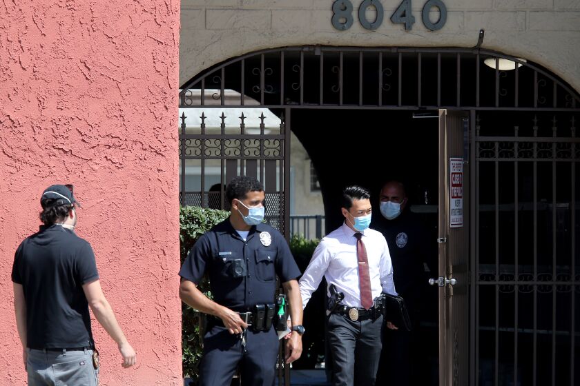 RESEDA, CA - APRIL 10, 2021:. Police conduct an investigation at an apartment building in Reseda where three children were reportedly stabbed to death by their mother on Saturday, April 10, 2021. The mother fled the scene but was later apprehended in the San Joaquin Valley. (Luis Sinco / Los Angeles Times)