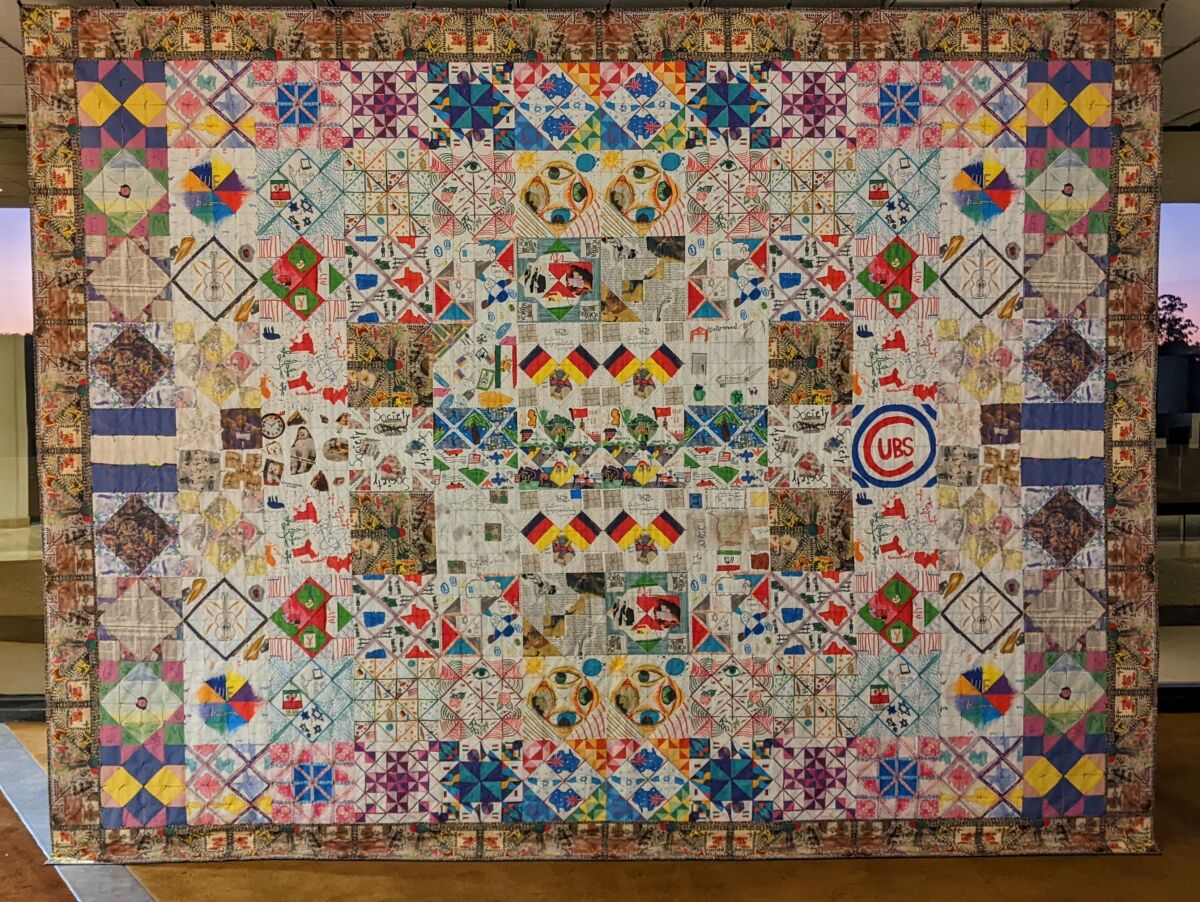 A quilt hung for viewing