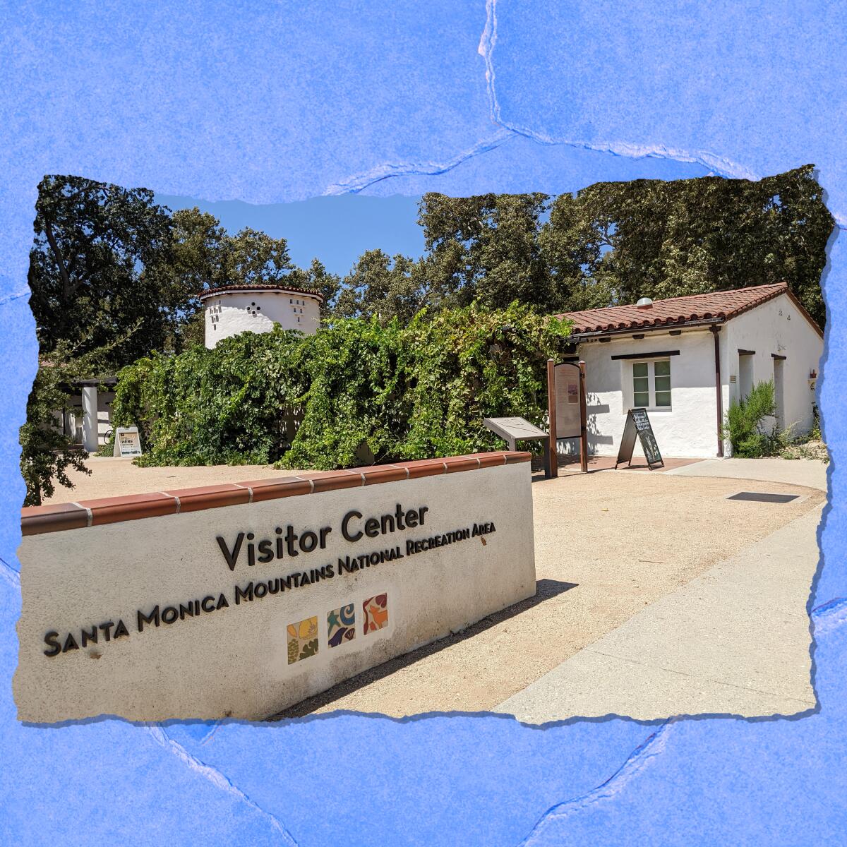 A wall near a small tile-roofed building reads "Visitor Center, Santa Monica Mountains National Recreation Area."