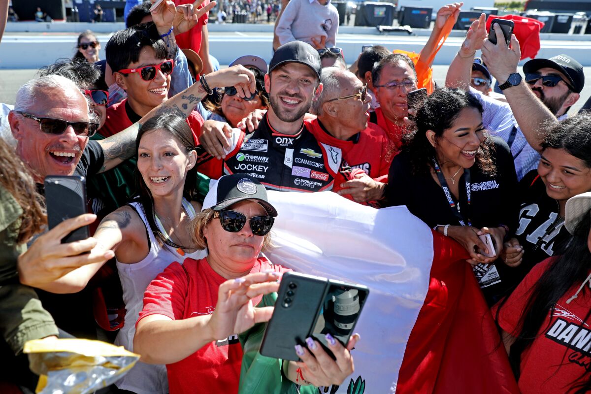 Daniel Suárez celebrates with fans after becoming the first Mexican-born driver to win a NASCAR Cup race.