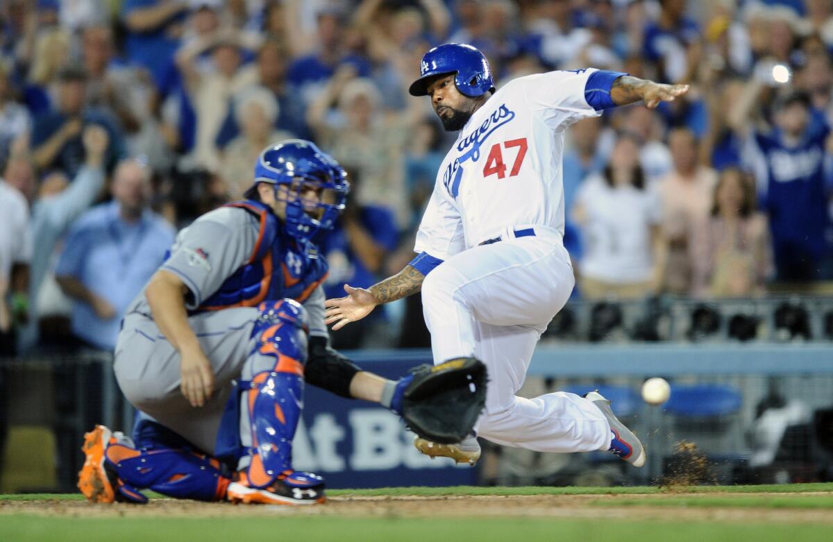 Howie Kendrick beats the throw to New York Mets catcher Travis d'Arnaud to score on a double by Adrian Gonzalez to deep right in the seventh inning of Game 2 of the NLDS