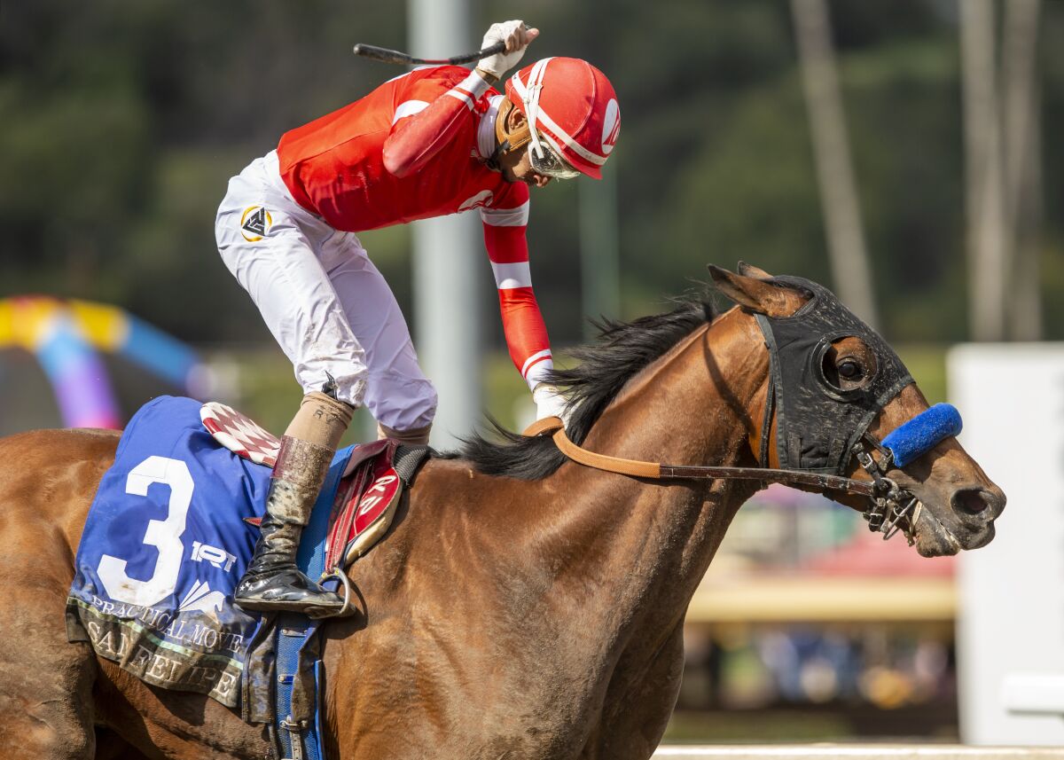 Jockey Ramon Vazquez celebrates after riding Practical Move to victory in the San Felipe Stakes on Saturday.