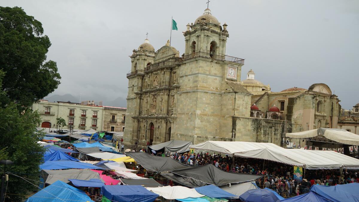 Protesting teachers have thrown up tents and canopies at the zocalo, or central plaza, in Oaxaca city, surrounding the Cathedral with plastic tents and tarps.