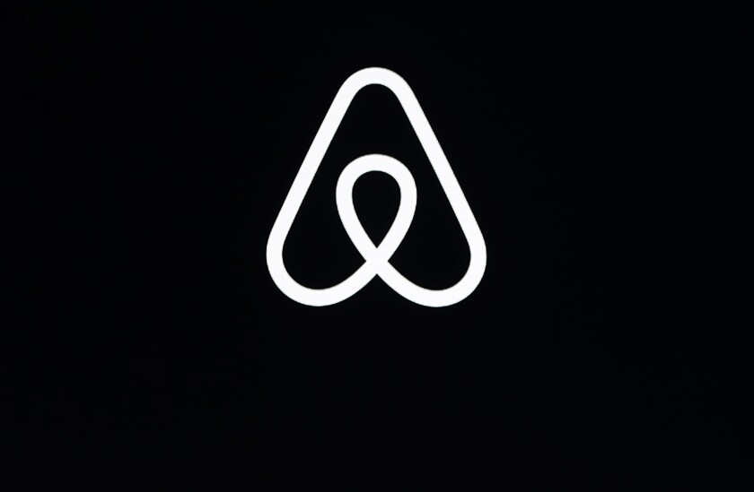FILE - This Feb. 22, 2018, file photo, shows an Airbnb logo during an event in San Francisco. Airbnb says it’s making its party ban permanent. The short-term-rental company said Tuesday, June 28, 2022 that the temporary ban it put into effect in 2020 is working, so it decided to make it permanent. (AP Photo/Eric Risberg, File)