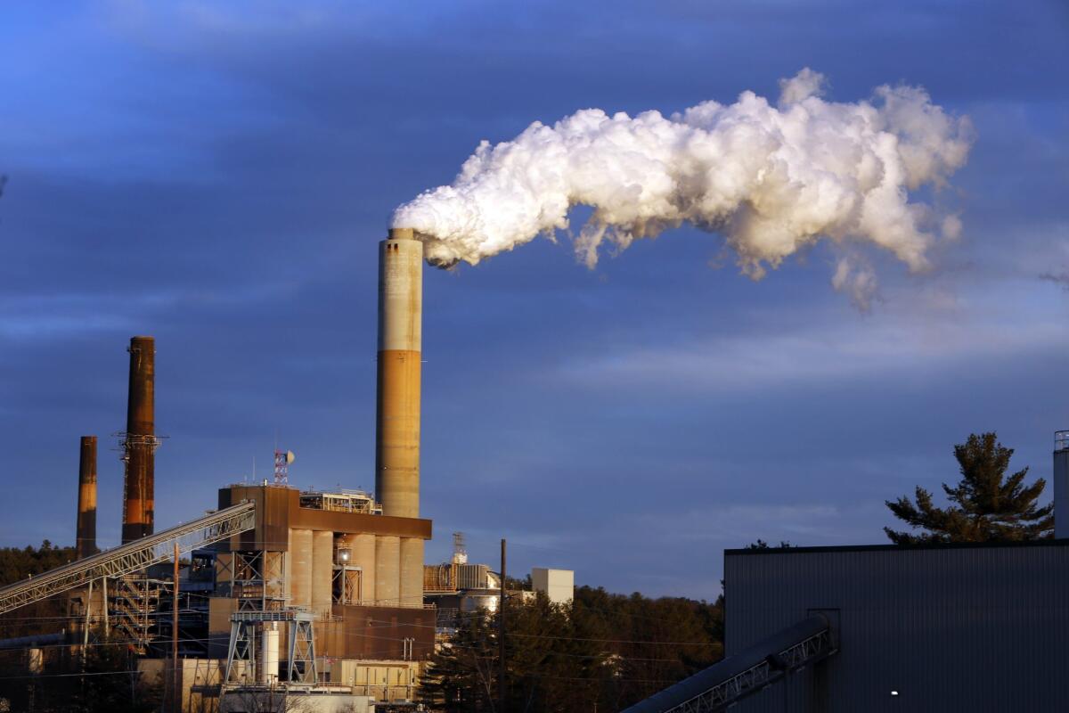 A plume of steam billows from the coal-fired Merrimack Station power plant in Bow, N.H. in January. Shutting coal mines and power plants around the country would mean the end of thousands of jobs.