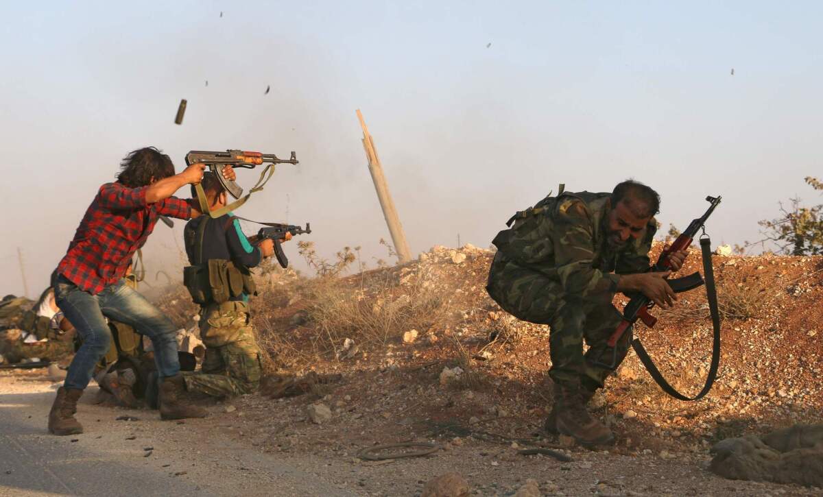 Syrian soldiers fire, repelling an attack in Achan, Hama province