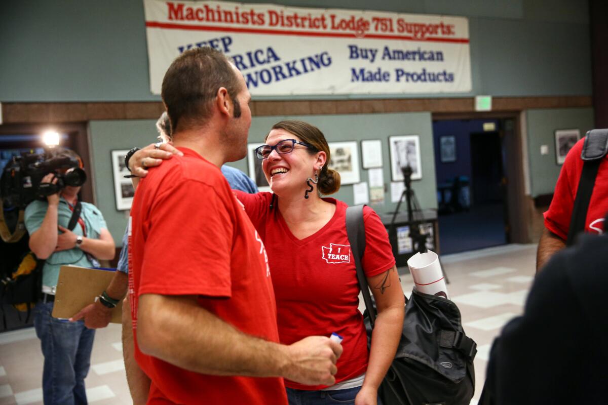 Union members embrace after Seattle Education Association leaders voted to suspend a strike Tuesday. Seattle educators approved a new contract for Seattle public schools on Sunday.