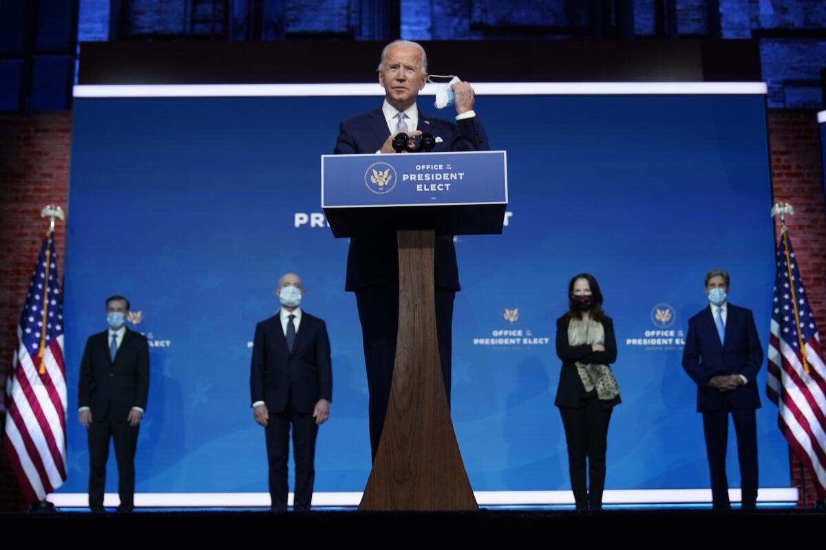 President-elect Joe Biden removes his mask to introduce his selections for key national security and foreign policy posts.